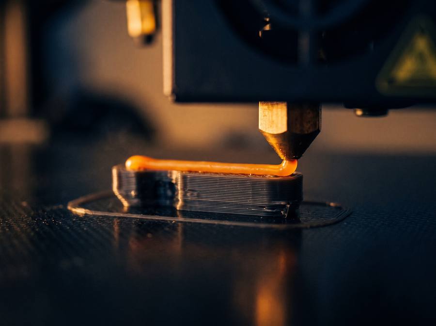 A 3D printer nozzle laying down a print